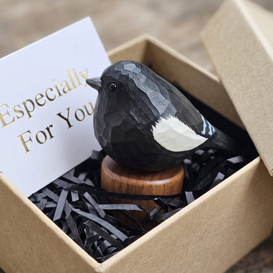 Hand-carved wooden Lark Bunting figurine in a kraft paper gift box with black paper shredding and an "Especially For You" card.