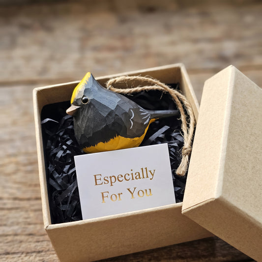 Hand-carved wooden Sultan Tit bird ornament inside an open kraft gift box with an 'Especially For You' card