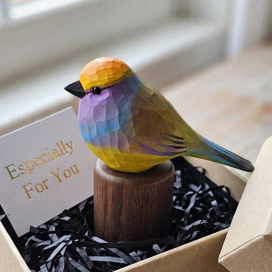Hand-carved wooden White-browed Tit-warbler figurine on a black walnut base inside an open kraft gift box with black shredded paper and an "Especially For You" card.