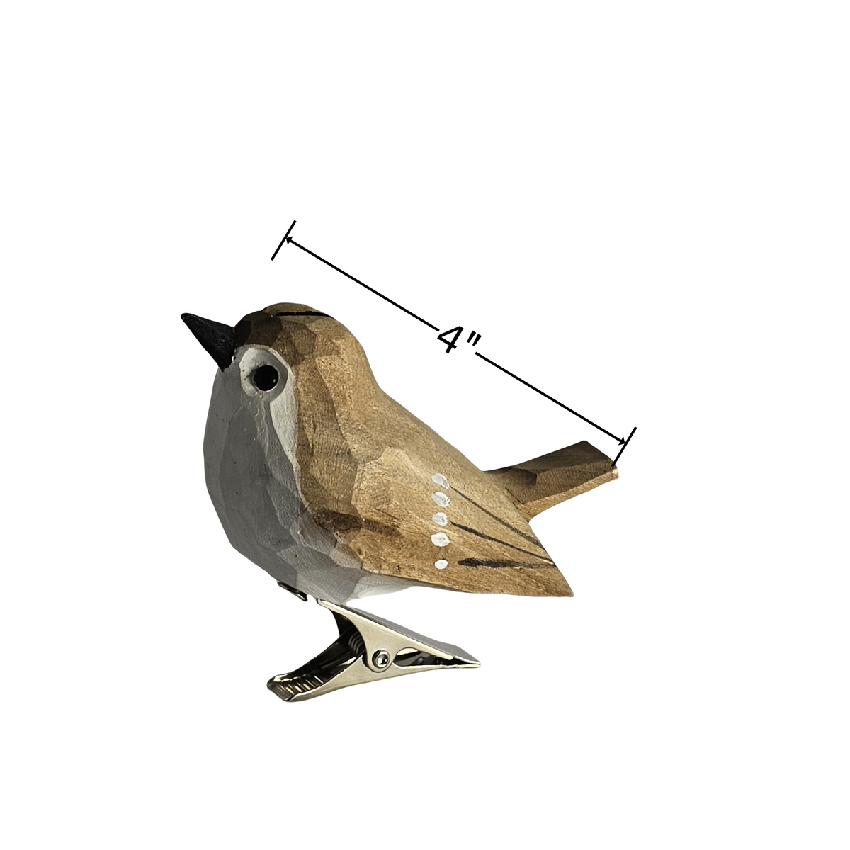 A side-profile shot of a hand-carved wooden Goldcrest bird ornament with a silver metal clip underneath, featuring light grey and brown plumage, a black-striped eye area, and a 4-inch dimension marker indicating its size, set against a plain white background.