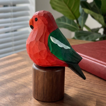 Hand-carved wooden Australian King Parrot figurine with a vibrant red body and green wing, mounted on a solid cylinder Black Walnut base