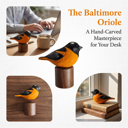A hand-carved Baltimore Oriole wooden bird figurine on a cylindrical wooden base, shown in multiple lifestyle settings including on a desk by a laptop and mug, on a windowsill with books, and as the central product shot. Text reads 'The Baltimore Oriole' and 'A Hand-Carved Masterpiece for Your Desk'.