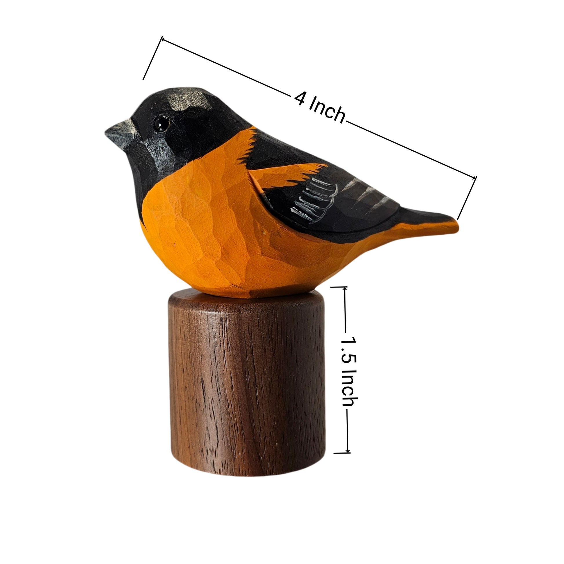 A carved wooden Baltimore Oriole figurine with a bright orange body, black head and wing, mounted on a cylindrical dark brown wooden base. Measurement lines and text indicating 4 Inch length and 1.