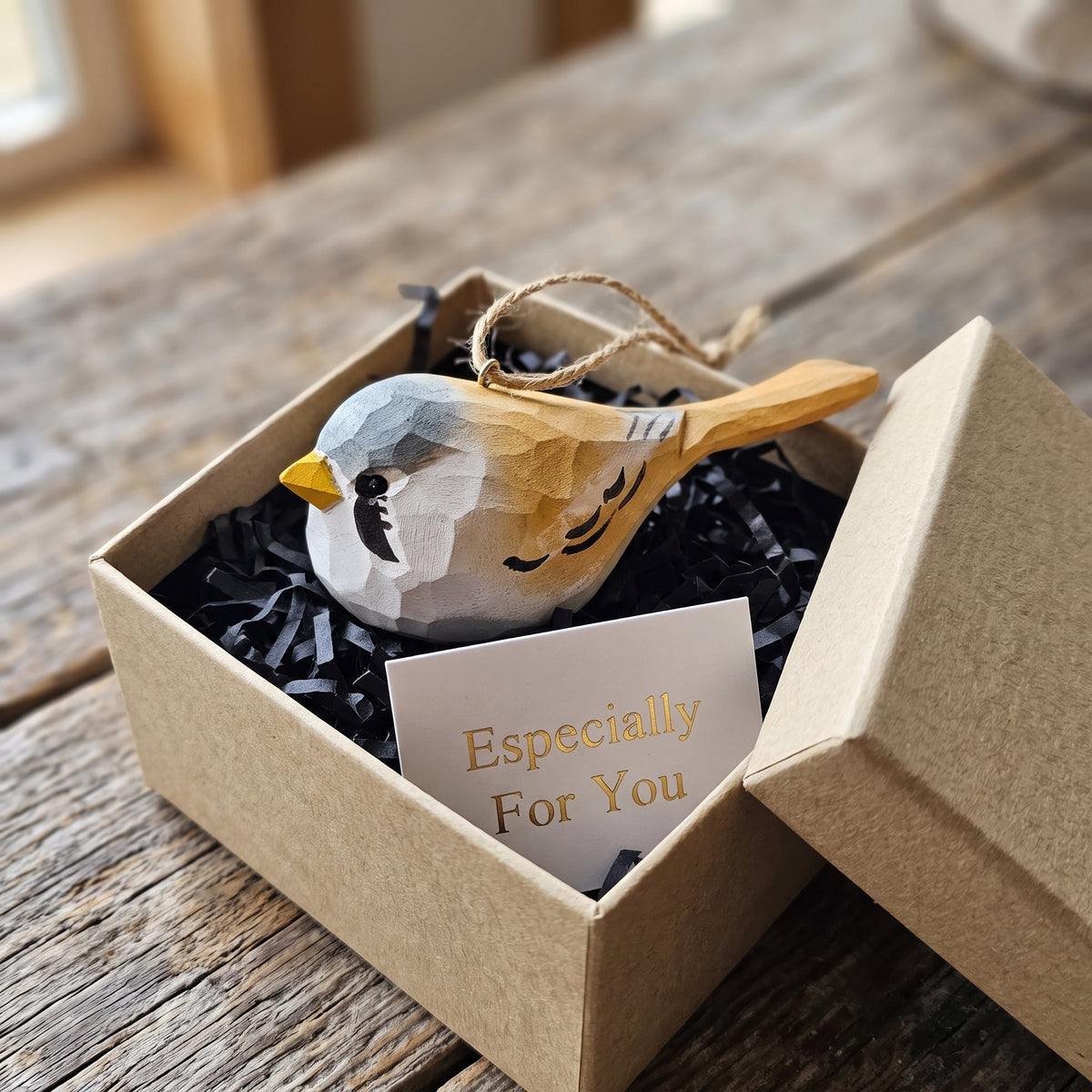 Hand-carved wooden Bearded Tit ornament packaged in a kraft gift box with an "Especially For You" card.