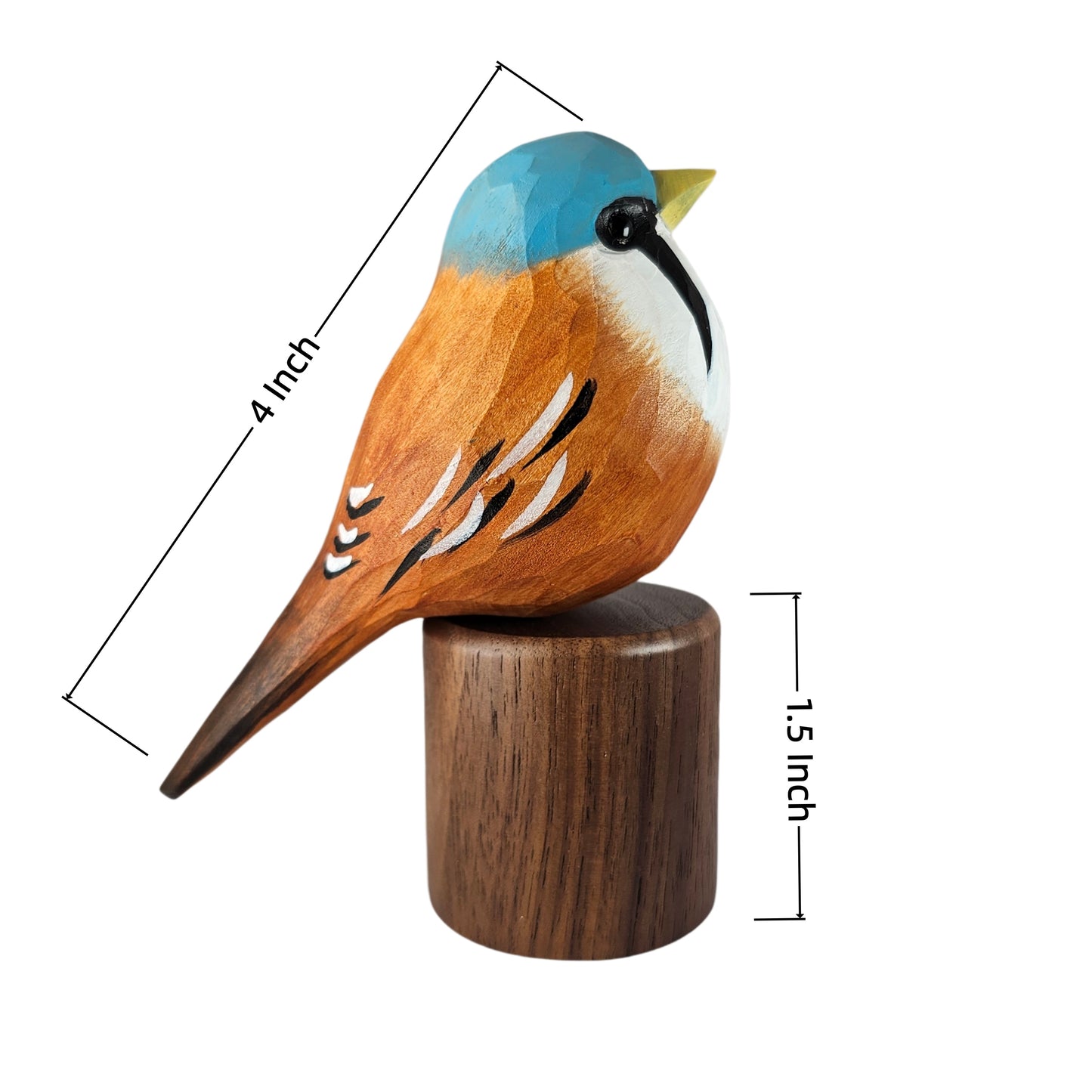 A carved wooden Bearded reedling figurine with a blue cap, orange-brown body, white chest, and yellow beak, mounted on a cylindrical wooden base. Black dimension lines and text show 4 inch length and 1.