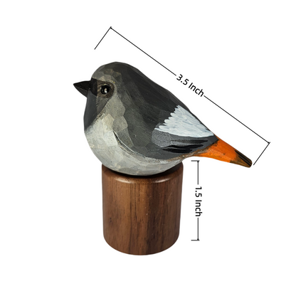 A painted Black redstart figurine on a wooden base with dimension lines showing 3.5 inch length, 1.