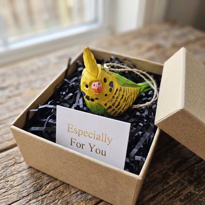 Yellow and green hand-carved wooden cockatiel ornament packaged in a gift box with an Especially For You card