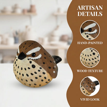 A hand-painted wooden Cactus wren figurine with a brown and beige spotted pattern, displayed on a white surface with a blurred pottery workshop background. The right side features a brown graphic overlay highlighting artisan details: hand-painted, wood texture, and vivid look.