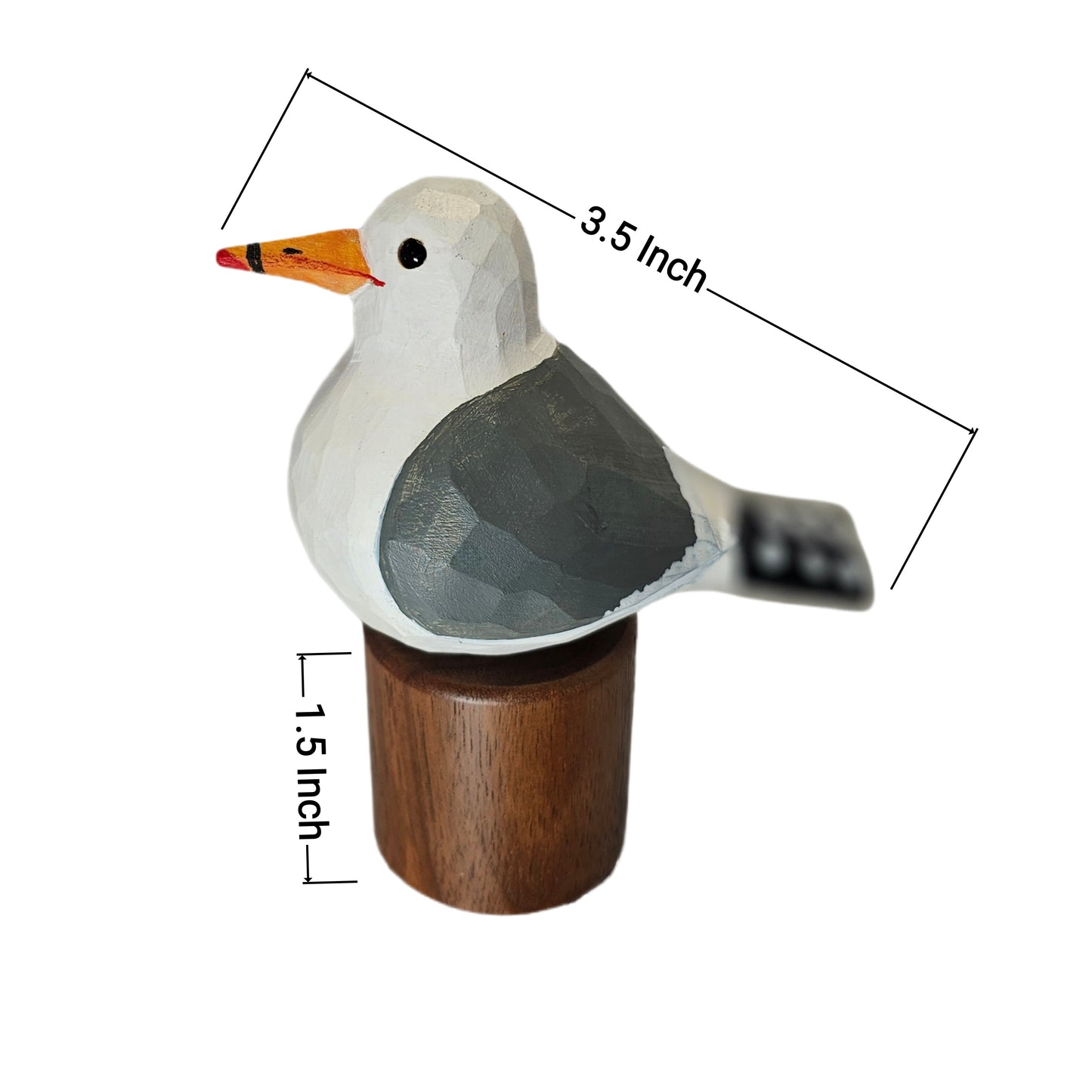 A small carved California gull figurine with a white head and body, gray wings, an orange beak, and a dark wooden base, shown on a white background with dimension lines indicating 3.5 inch length and 1.