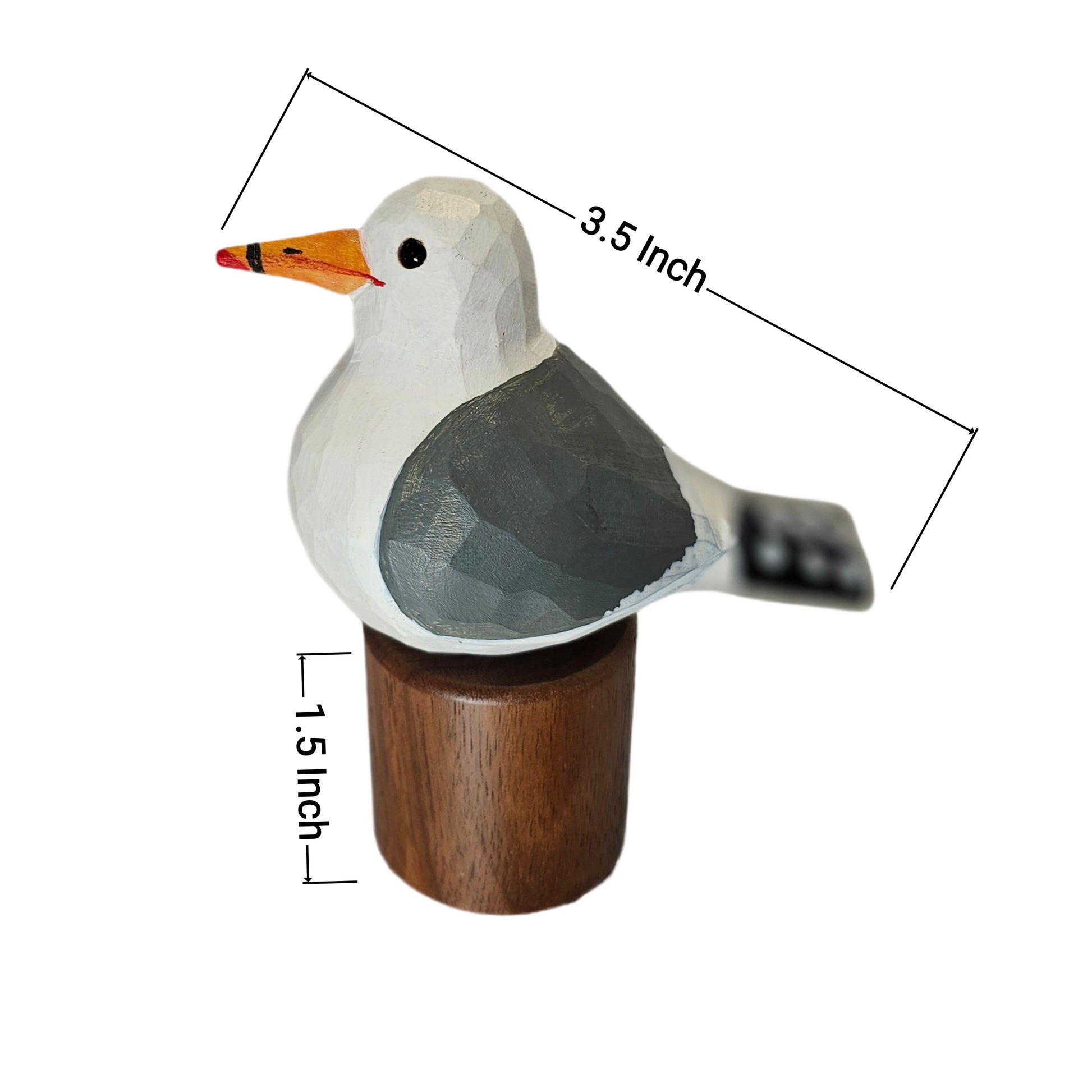 A small carved California gull figurine with a white head and body, gray wings, an orange beak, and a dark wooden base, shown on a white background with dimension lines indicating 3.5 inch length and 1.