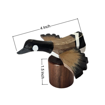 A handcrafted wooden Canada Goose Flying deco sculpture mounted on a cylindrical wooden base, with dimension lines indicating a length of 4 inches and a height of 1.5 inches, set against a plain white background.