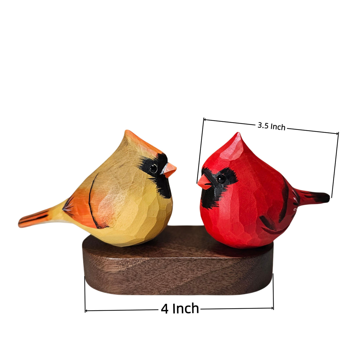 Two hand-carved wooden cardinal bird figurines on a dark wooden base, with dimension lines showing 3.5 inch height, 4 inch width, and 4 inch depth on a white background.