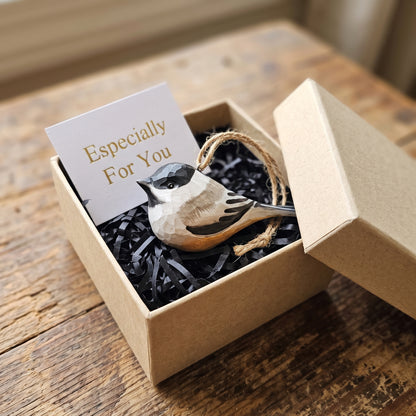 Hand-painted wooden Black-capped Chickadee ornament with jute string nestled in a gift box with a card reading "Especially For You".