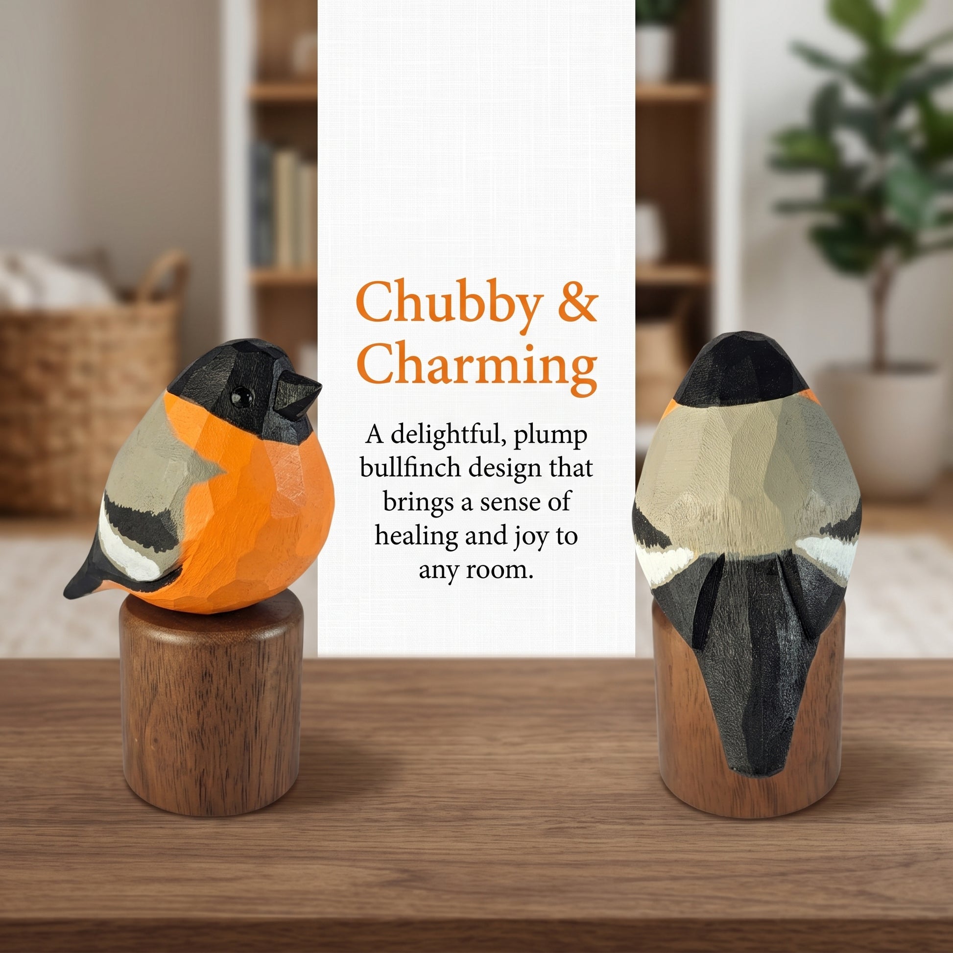 Two hand-painted wooden Eurasian bullfinch sculptures on cylindrical wooden bases, displayed on a wooden table in a softly blurred home interior. A central white text panel reads 'Chubby & Charming' with descriptive copy.