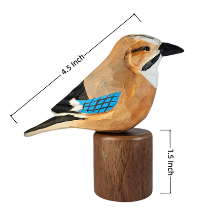 A carved wooden Eurasian jay figurine perched on a cylindrical wooden base, shown on a white background with dimension lines indicating 4.5 inch length and 1.