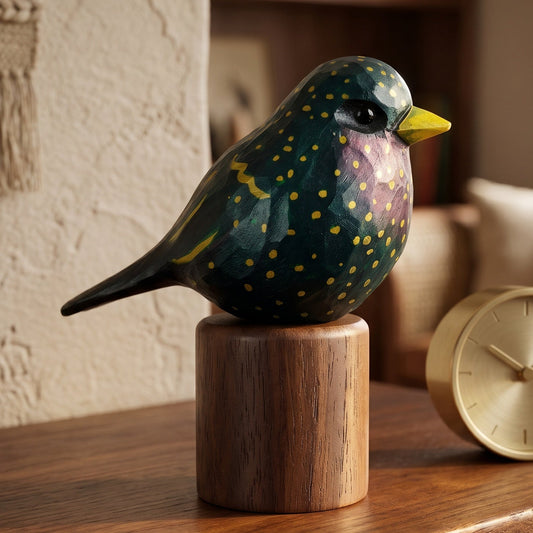 Hand-carved wooden European Starling figurine with iridescent plumage on a round wooden display bas