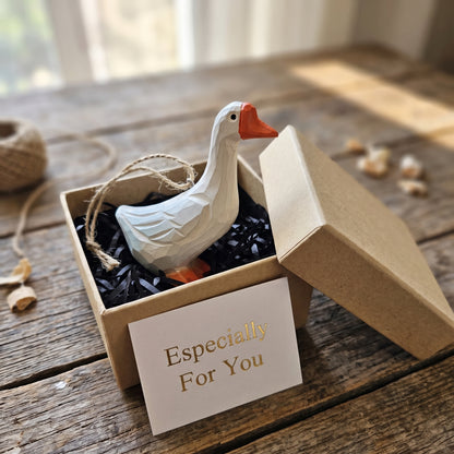 Hand-carved white goose wooden ornament inside a kraft gift box with an 'Especially For You' card