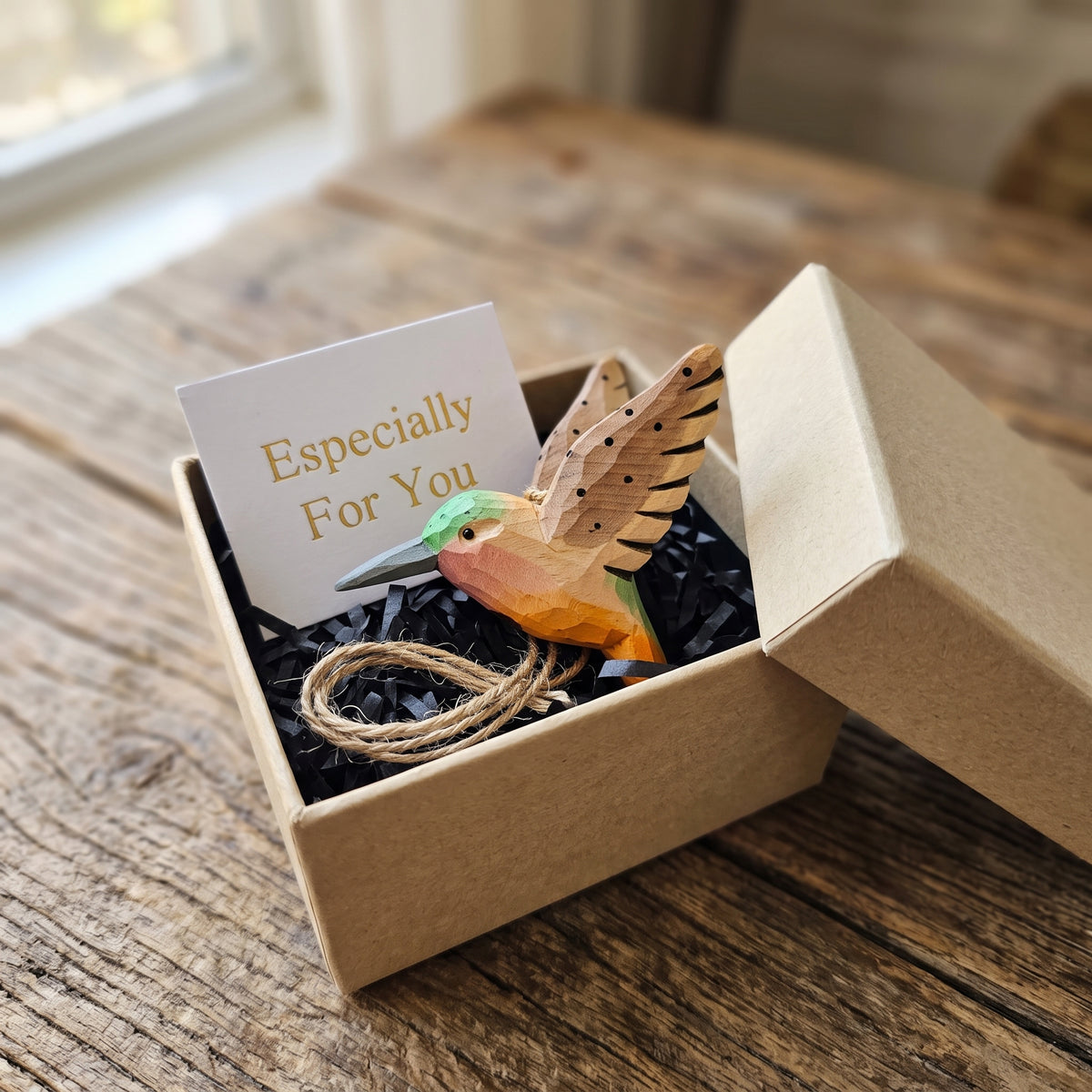 Hand-carved wooden hummingbird ornament packaged in a craft gift box with a card reading "Especially For You".