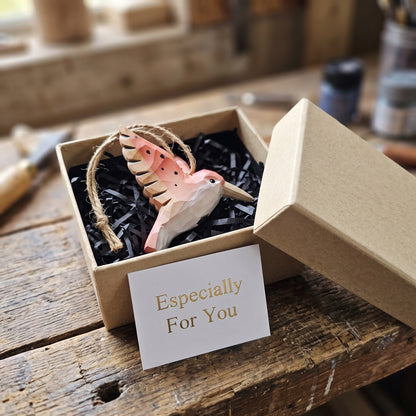 Hand-carved wooden pink hummingbird ornament packaged in a kraft gift box with an "Especially For You" card.