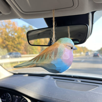 Hand-carved basswood Lilac-Breasted Roller ornament hanging from a car rearview mirror