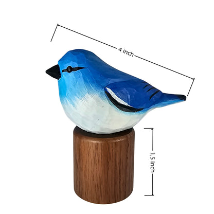 A painted Mountain bluebird figurine on a cylindrical wooden base, shown with dimension lines indicating a height of 1.5 inch and a length of 4 inch on a plain white background.