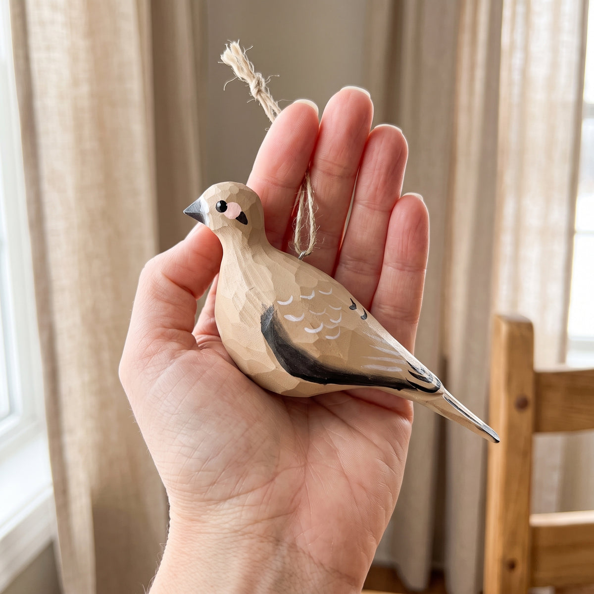Hand-painted wooden Mourning Dove bird ornament held in hand for scale