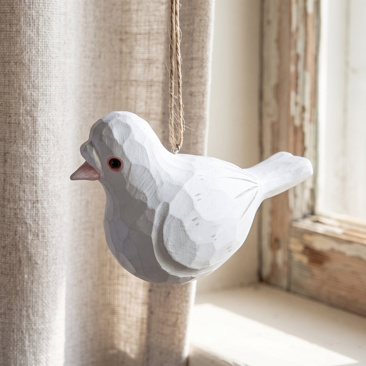 Hand-carved white wooden baby pigeon hanging ornament.