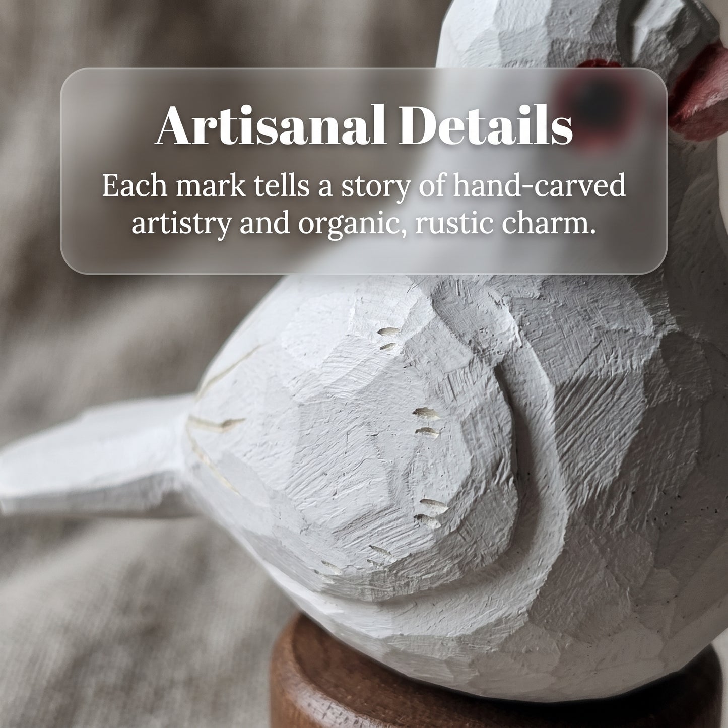 A close-up of a hand-carved wooden Pigeons figurine in an off-white finish, mounted on a round wooden base. A translucent text overlay reads 'Artisanal Details' with descriptive copy about hand-carved artistry.