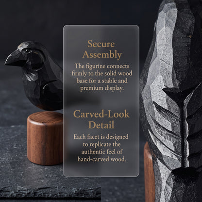 A dark gray rectangular product info card with gold text, placed in front of a carved black raven figurine on a wooden base. The card reads: 'Secure Assembly' and 'Carved-Look Detail.