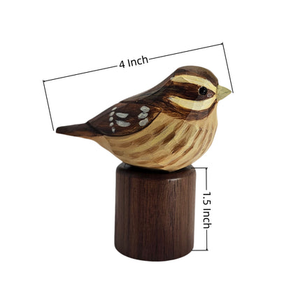 A carved wooden Rose-breasted Grosbeak figurine perched on a cylindrical wooden base, shown on a white background with dimension lines indicating a height of 1.5 inch and a width of 4 inch.