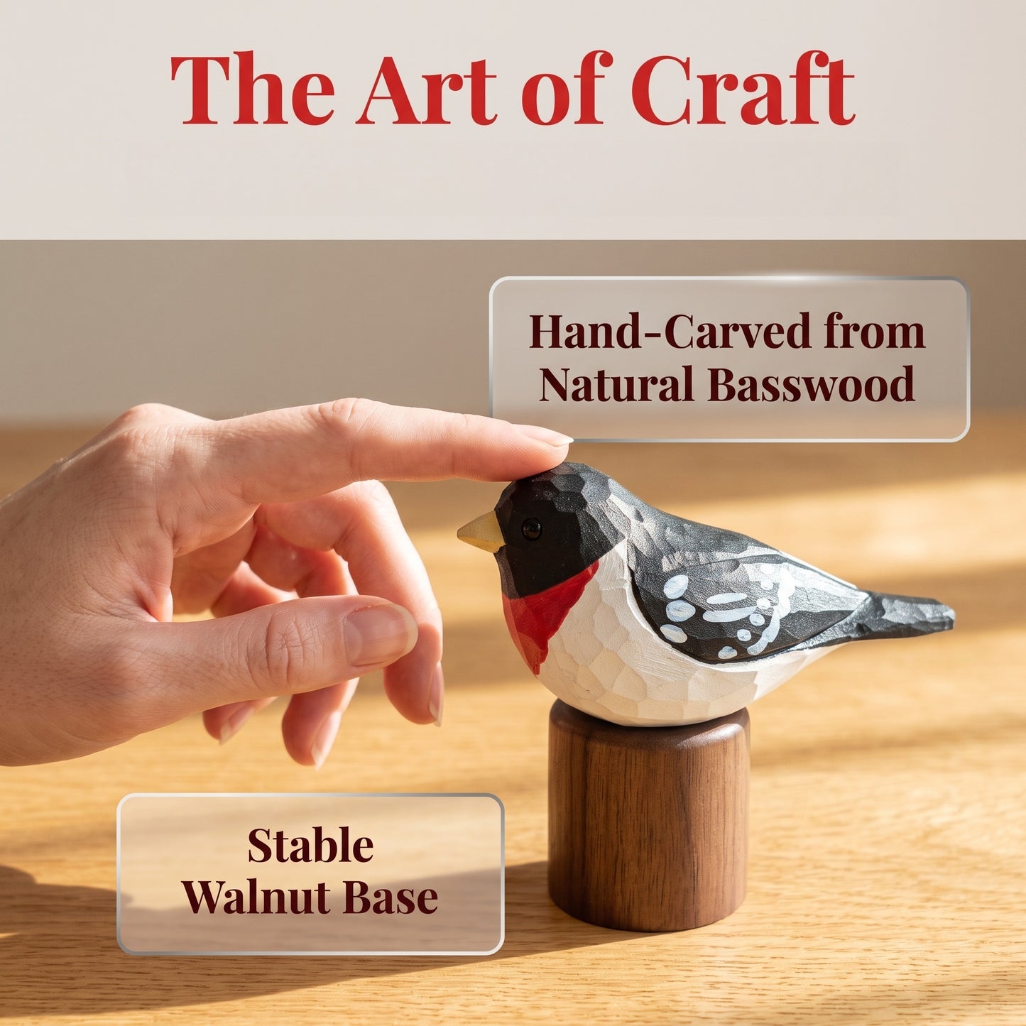 A hand points toward a hand-carved Rose-breasted Grosbeak figurine on a walnut base, with text overlays reading 'The Art of Craft,' 'Hand-Carved from Natural Basswood,' and 'Stable Walnut Base.'.
