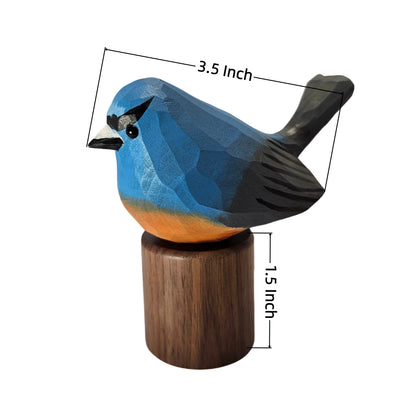 A carved wooden Snowy-browed flycatcher figurine with a blue, black, and orange color scheme, mounted on a cylindrical wooden base. Black dimension lines with text overlays indicate a length of 3.