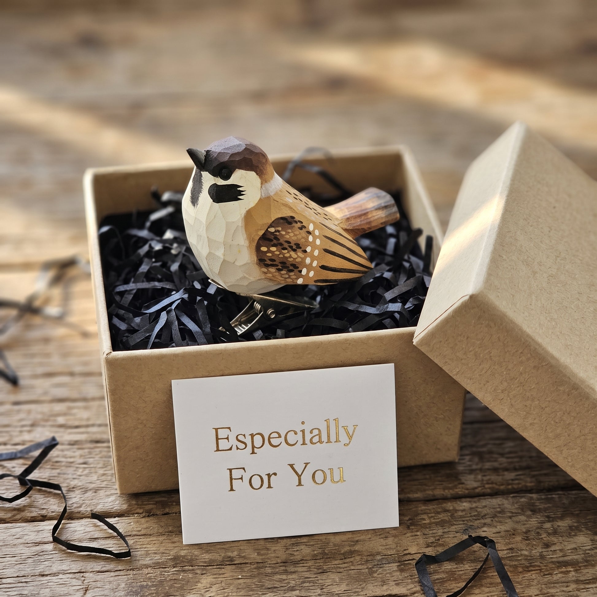 Hand-carved wooden sparrow ornament packaged inside a gift box